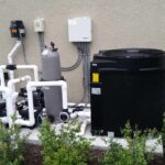 Shot of a pool pump system next to an electric pool heater outside of a residential home