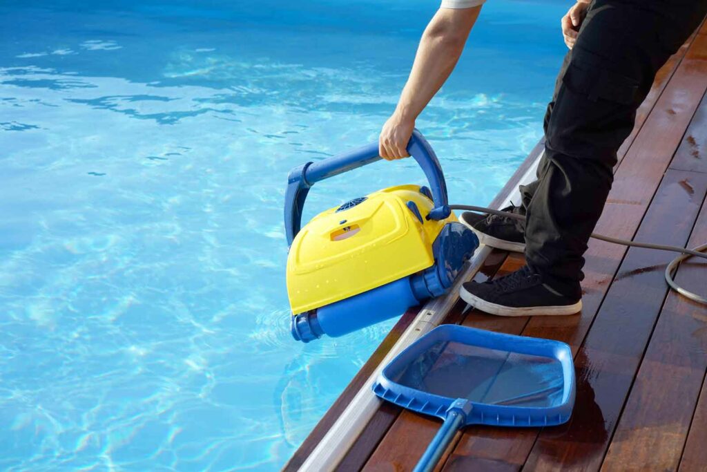 Pool Equipment being lifted by professional out of a pool